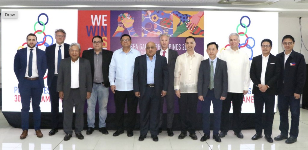 SEA Games officials and partners pose during a Phisgoc presentation with We Win As One backdrop
